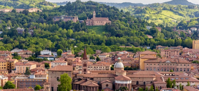 Panoramic view of the city of Bologna and the building San Michele in Bosco located in the hills above the city